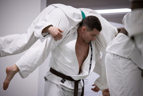 A man being thrown during judo in Ann Arbor