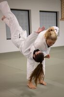 A woman flipping someone in jujutsu in Ann Arbor