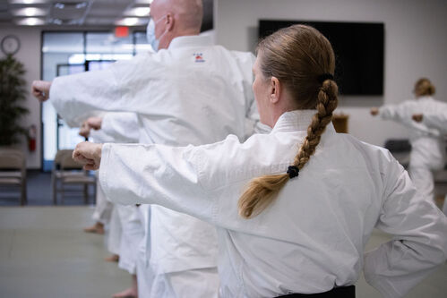 A woman punching during karate in Ann Arbor
