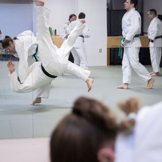 Two people fighting in judo, practicing self-defense in Ann Arbor