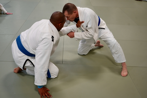 Two JMAC Ann Arbor students practicing Brazilian Jiu-Jitsu/Kozen Grappling techniques on spring board floors 