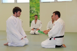 Student beginning his journey in martial arts by receiving his first promotion.