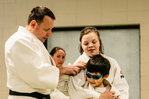 A judo instructor instructing two judo students | kids judo Ann Arbor